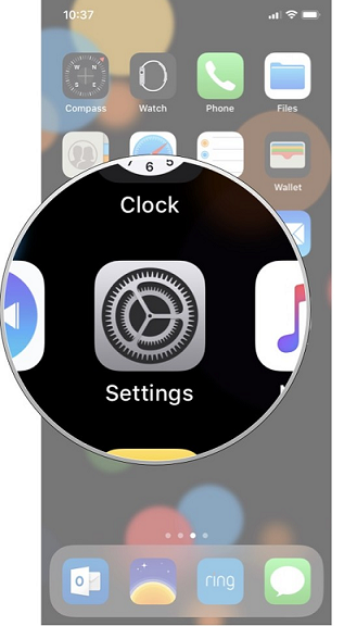 iPhone home screen with the Settings app icon magnified