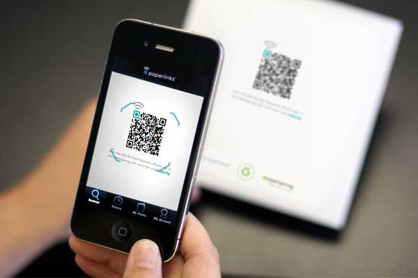 Phone scanning a QR code printed on a box with the Paperlinks app
