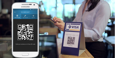 Phone scanning a merchant QR code to pay at a shop counter
