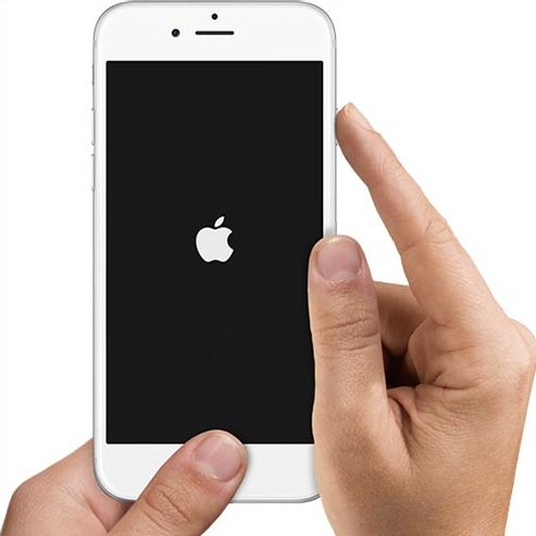 Hands pressing the buttons on an iPhone to force restart it, with the Apple logo on screen