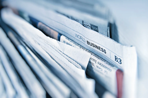 Close-up of a stack of folded newspapers with a World Business section on top